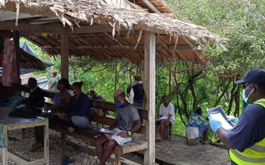 A Solomon Island Red Cross staff speaks to the community on hygiene measures to stay safe from COVID-19