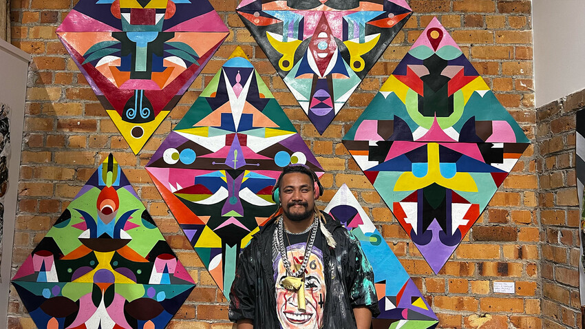 Core Selekā member, Yazmin Ahohako (Cyclops) in front of his work